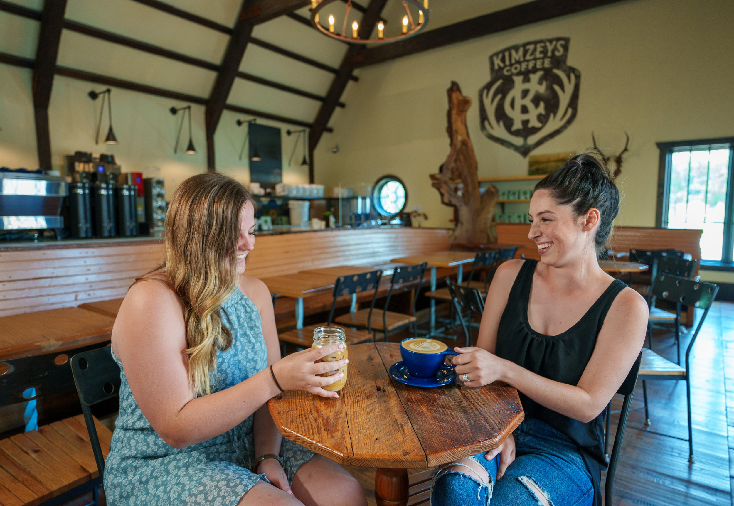 two women drinking coffee at kimzey's coffee