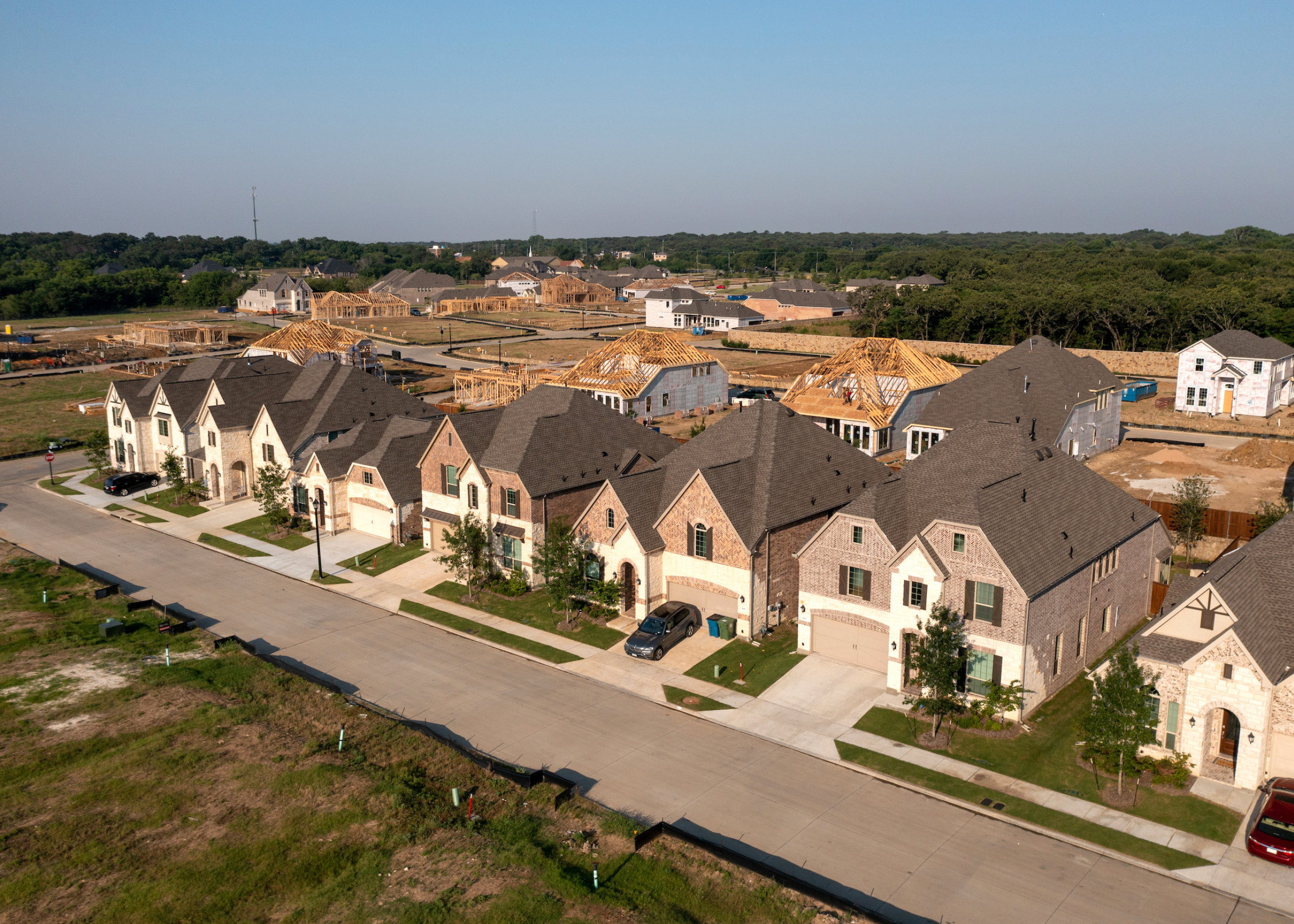 aerial photo of new homes being built behind a row of finished homes