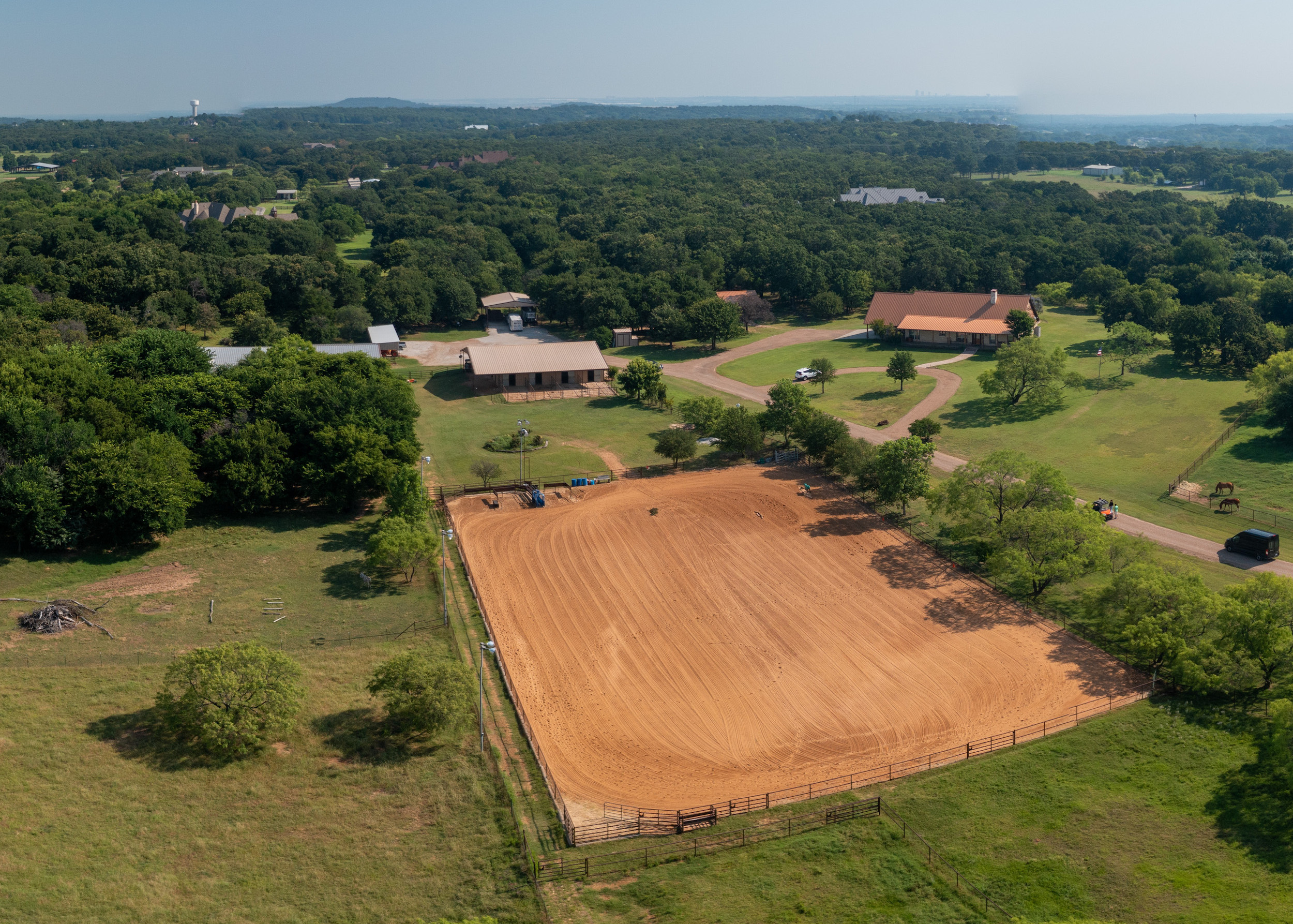 aerial photo of home, corral, barn, and horses.
